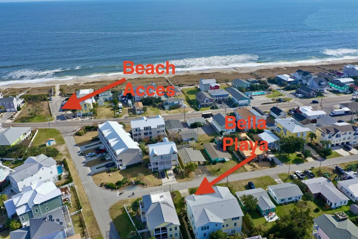 An exterior perspective featuring the beach, neighborhood layout, and direct beach access. The image captures the relaxed atmosphere of the area and the proximity to year-round coastal adventures and community events.